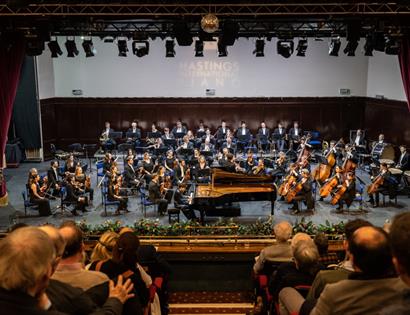 orchestra on stage with conductor