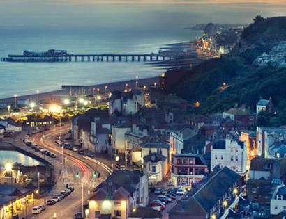 high view of town in twilight with sea in the background