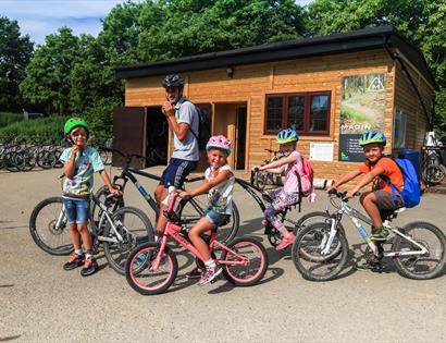 family on bikes outside hire shop