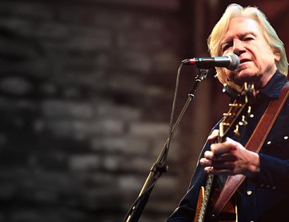 Justin Hayward playing guitar on stage