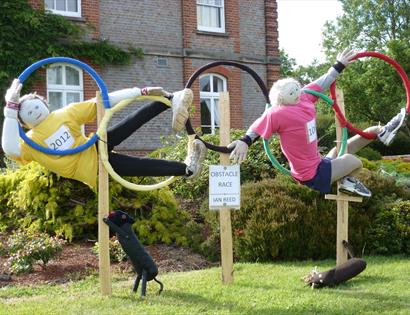 Scarecrows in Olympic hoops at Battle Scarecrow Festival