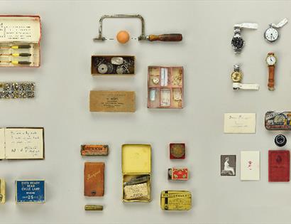 A collection of objects and memorabilia, laid out in block formation.