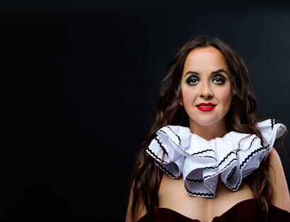A portrait of a woman wearing a clown's ruff.