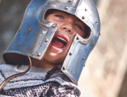 young boy in knight's helmet