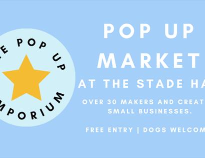 Blue poster with circular logo for the pop up emporium and a yellow star.