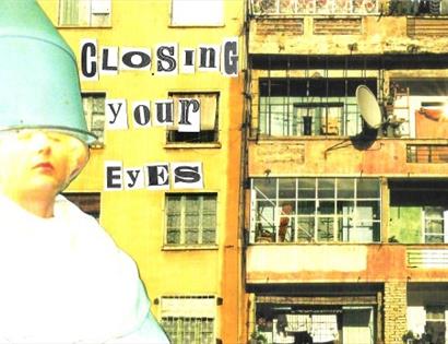 a poster with a woman with a bucket on her head captioned 'closing your eyes'