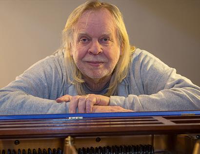 Rick Wakeman sitting at a piano