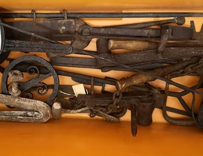 yellow museum box full of iron objects