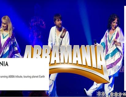 Poster for ABBAMANIA at White Rock Hastings, showing ABBA tribute performers on stage in bright costumes under blue lights.