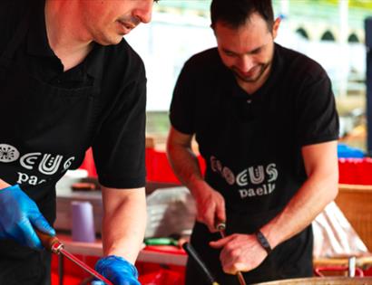 two chefs wearing black crocus paella t-shirts. For the hub bodiam food event, rother