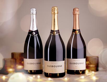 Photograph of three champagne bottles with bokeh effect.