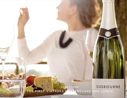 photo showing Gusbourne wine bottle on an al fesco table.