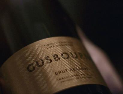 Close up photo of a gold Gusbourne Estate logo.