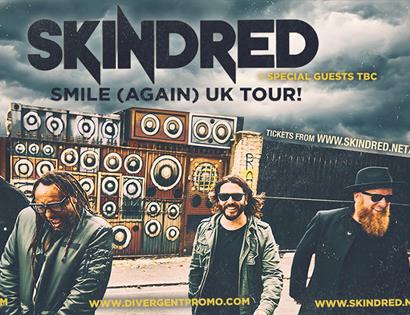 Skindred band performing in front of a wall of speakers