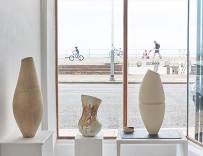 ceramics in front of a window with street scene.