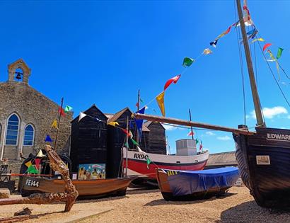 coloured bunting, black net huts and fishing boats
