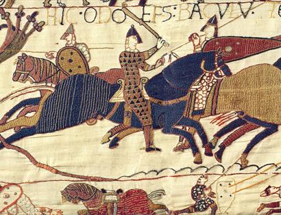 a section of the Bayeux tapestry, medieval embroidery shoes stitched image of a knight with helmets and swords on horseback.