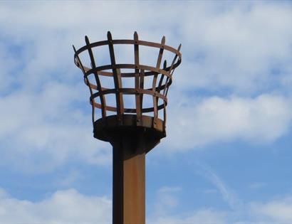 beacon unlit against blue sky
