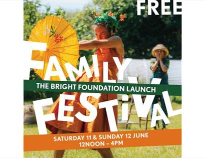 poster shows girl in orange dress holiding out paper umbrella. free family festival written on top