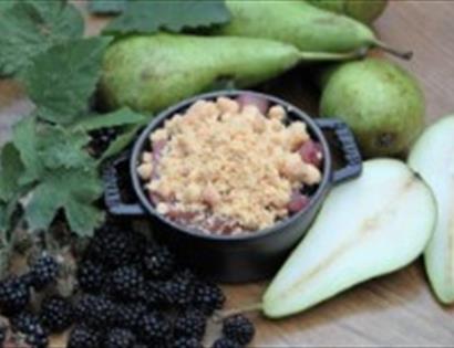 Backed pot with handles surrounded by pears and blackberries
