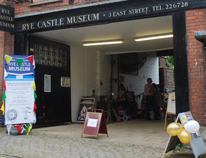 exterior of Rye Castle Museum, with balloons and display boards.