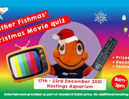 A poster for Hastings Aquarium chirstmas event showing a clown fish costume with santa hat, tv and remote.