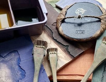 Image shows the tools used for Japanese Woodblock Printing including brushes and ink.