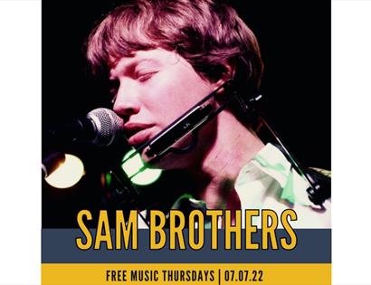 poster for sam brothers gig shows man singing into microphone