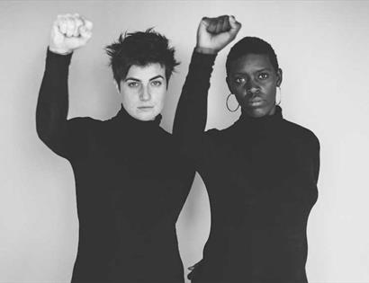 Photo of two women, one black, one white.