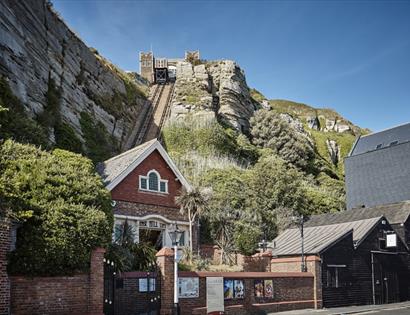 photograph of the east hill from the lower station. Shows brick building at the bottom of funicular railway cut into cliff.