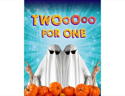Image shows two people with white sheets over them dressed like ghosts with sunglasses on. The bottom of the image has pumpkins scattered across. Text