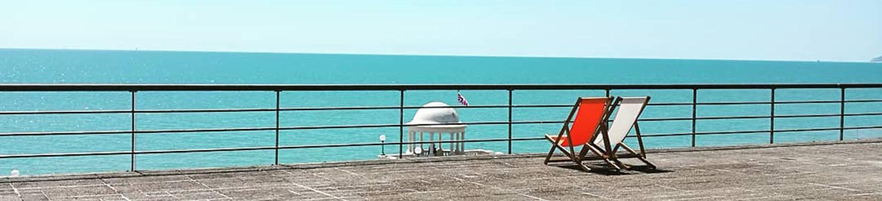 Deckchairs on De La Warr Pavilion roof overlooking sea