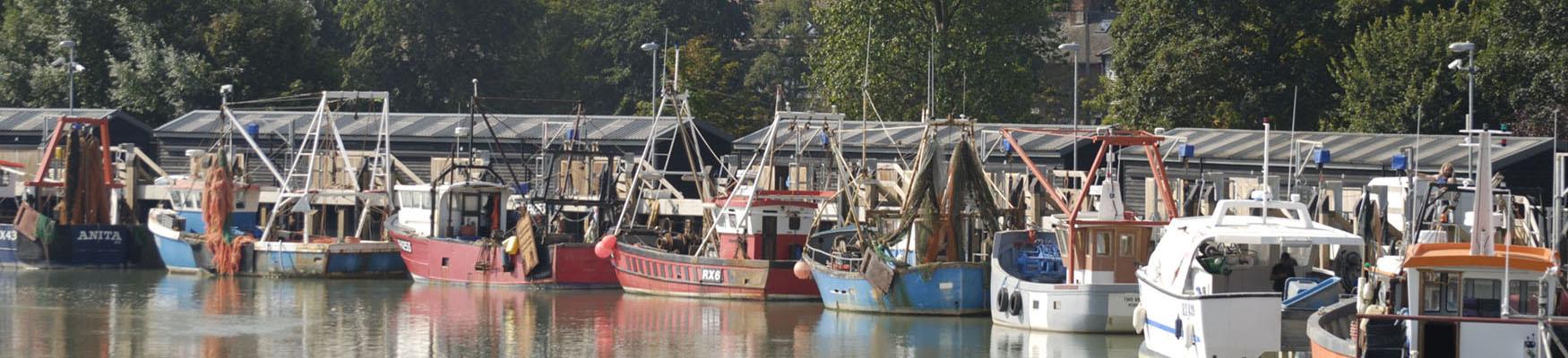 Boats reflected in the water in Rye Harbour