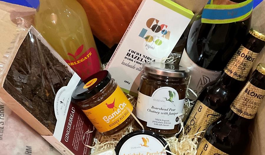 hamper of produce including, glass bottles of fresh fruit juice, beer, wine, gingerbread and jams.