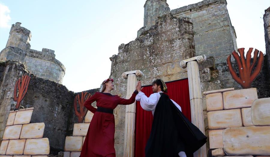 medieval style actors in the grounds of a castle.