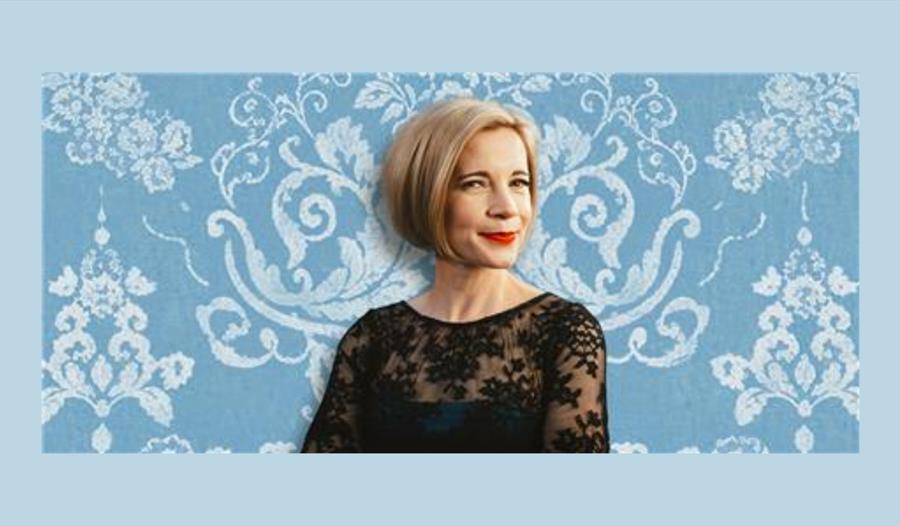 Lucy Worsley with a blue background