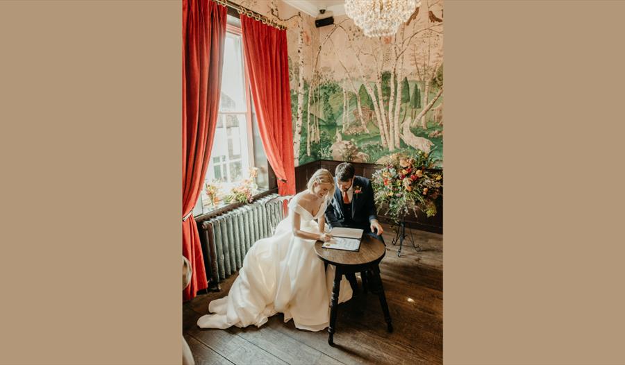 man and wife signing register after getting married