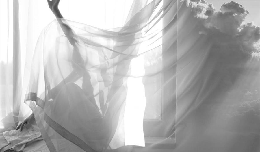 black and white photograph with sheets and clouds