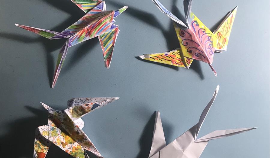 A photograph of four origami birds.