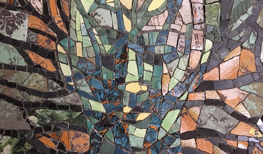 an abstract mosaic like painting of a mans face and a tree.
