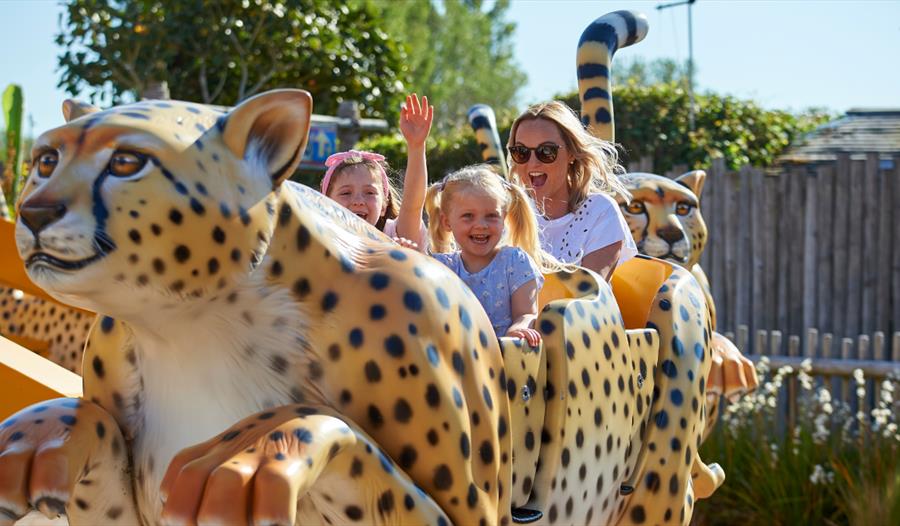 Children enjoying animal train ride at Drusillas Park.