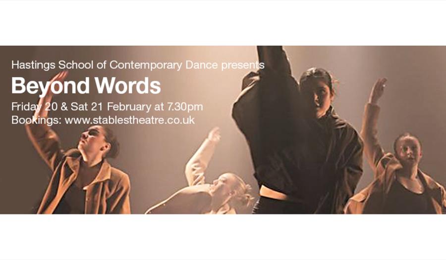 Contemporary dancers performing onstage in dramatic lighting beside text promoting the show ‘Beyond Words’.