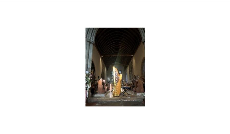 Harpist performing in a church interior with light streaming through stained glass for Twilight Resonance recital.