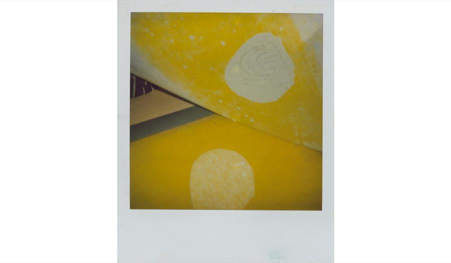 Abstract yellow-toned artwork featuring layered geometric forms and pale circular motifs from the Parallel Lives exhibition.