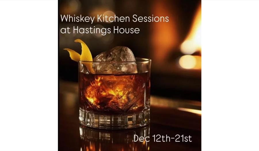 Glass of whiskey with ice and orange peel in front of a fire, text reads Whiskey Kitchen Sessions Dec 12–21.