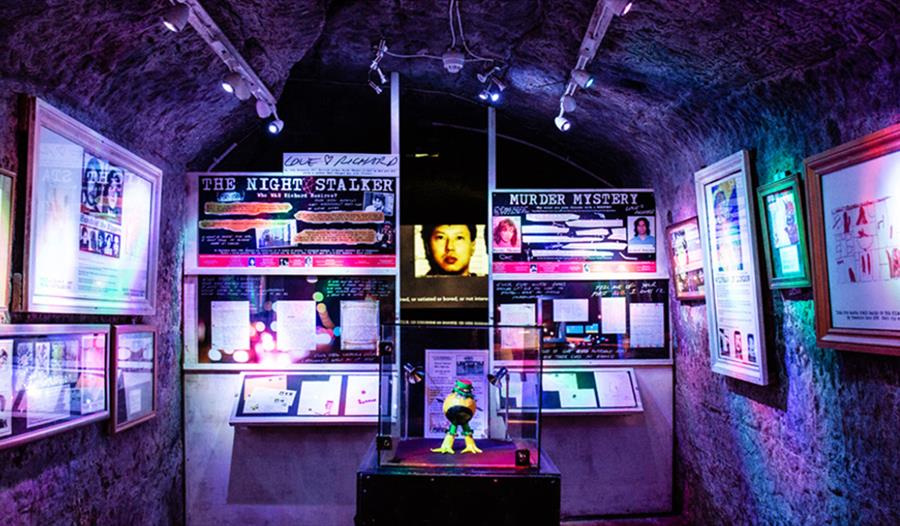 Colourful underground exhibit at Hastings’ True Crime Museum featuring displays on notorious criminal cases.