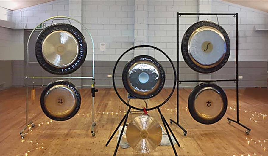 A photograph of five gong instruments in a studio.
