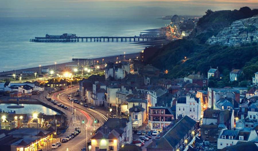 high view of town in twilight with sea in the background