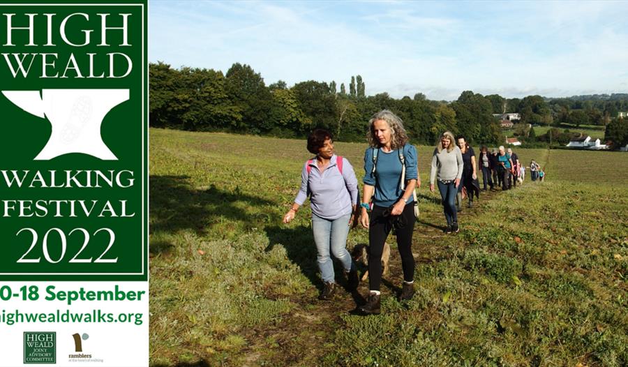 Poster for High Weald Walking Festival, group of walkers crossing a field.