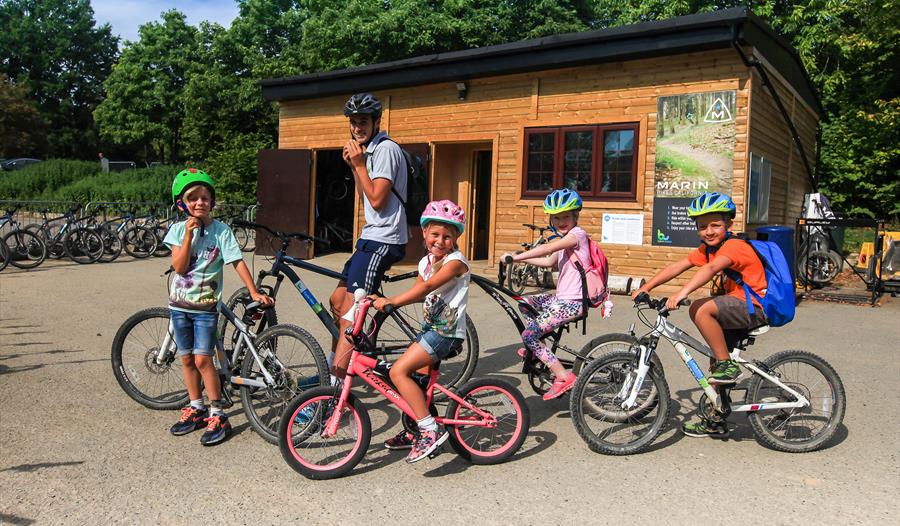 family on bikes outside hire shop